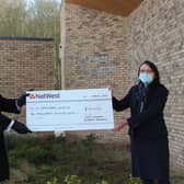 Carlton Bradley and Deborah Balsdon with the cheque