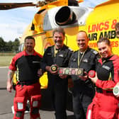 Lincs & Notts Air Ambulance is going cheesy with The Mouse House. Some of the air ambulance crew is pictured with one of the charity cheese boxes, where an £8 donation from each purchase will go to the LNAA. Image: LNAA