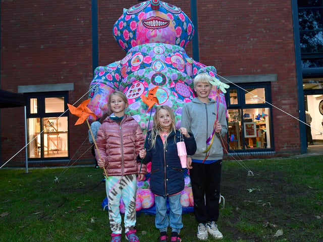 L-R Scarlett Phillips 8, Violet Phillips 5, and Ethan Lowde 11 of Sleaford with one of the inflatable creations on Eastgate Green, Jason and his Argonauts, by Jason Wilsher Mills.