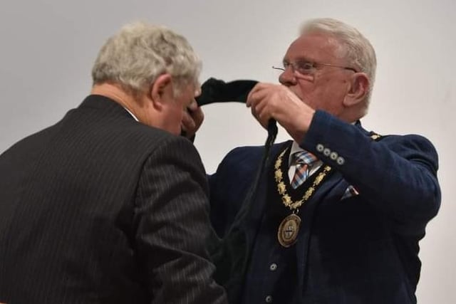 Mayor of Slegness Coun Tony Tye hands the chain of office to his deputy Coun Pete Barry.