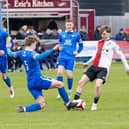 Trinity and Woking in the heat of FA Trophy battle on Saturday.