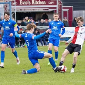 Trinity and Woking in the heat of FA Trophy battle on Saturday.