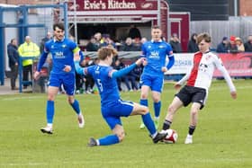 Trinity and Woking in the heat of FA Trophy battle on Saturday.