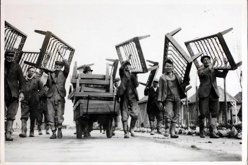 An army of workmen carrying bedsteads to the 1,000 chalets at Butlin's holiday camp in readiness for the first of the holiday makers.