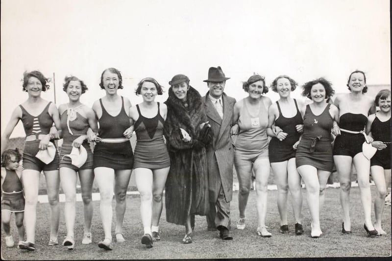 English aviator Amy Mollison (Amy Johnson) with a group of bathers and her husband Jim Mollison after opening the bathing pool at Butlin 's Holiday Camp at Skegness.