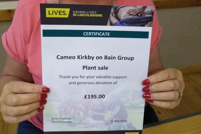 Chairman Louise Roberts with the certificate from LIVES.
