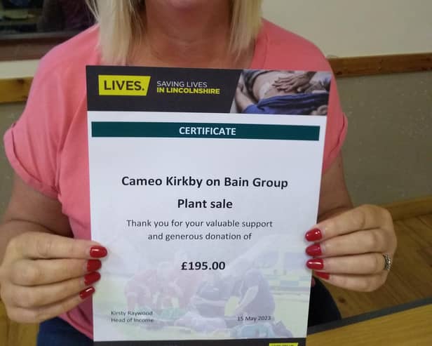 Chairman Louise Roberts with the certificate from LIVES.