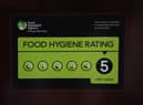 A Food Standards Agency rating sticker on a window of a restaurant in central London. A huge variation in food hygiene standards remains across the UK, with one in five high or medium-risk food outlets failing to meet standards, according to a study.