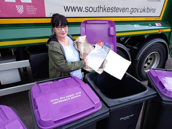 SKDC Cabinet Member for Environment and Waste, Coun Patsy Ellis, demonstrating what to put in the new purple bins for South Kesteven households. Photo: SKDC