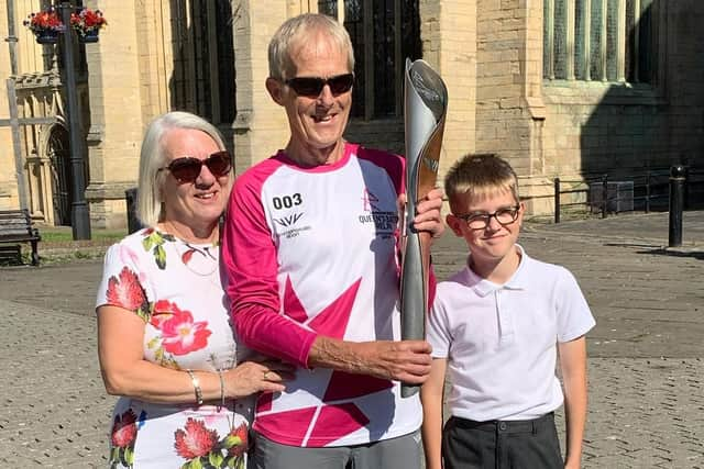 Baton bearer Peter Ward, with his wife Tina Ward and grandson Hugo Ward.