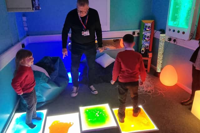 Staff and youngsters try out the new sensory room at Coningsby St Michael's Church Of England Primary School.