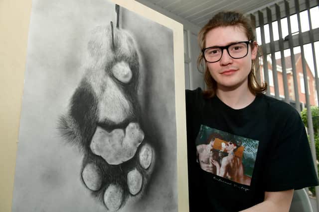 Levi Hurst with his award-winning artwork.