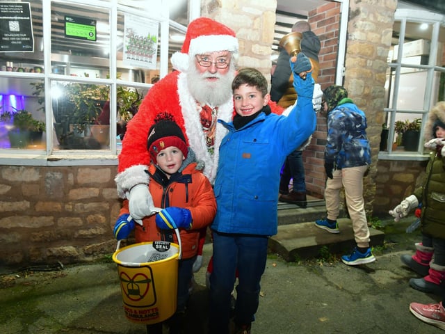 Father Christmas with Alfie 7 and Ruben 3 who got to ring his bell. Photo: David Dawson