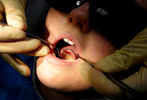 File photo dated 19/05/11 of a dentist at work. Adding fluoride to water supplies offers only a modest benefit to the dental health of children, researchers have found. The scientists said water fluoridation can be seen as a cost-effective way to help reduce some of the £1.7 billion a year the NHS spends on dental caries. Issue date: Monday November 14, 2022.