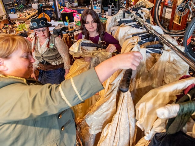Searching through the preloved dresses.