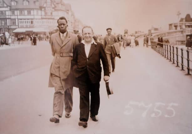 Bulaya Chanda walkin along Skegness promenade with Billy Butlin.
