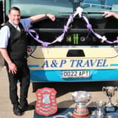 ​Director Paul Cartwright (right) and driver Terry Baker with the trophies.
