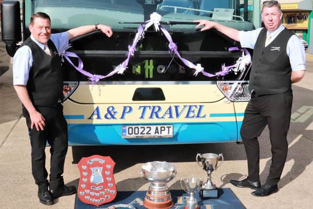 Director Paul Cartwright (right) and driver Terry Baker with the trophies.