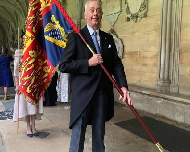 Francis Dymoke with the Royal Standard at the King's Coronation this year.