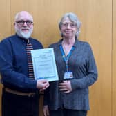 Anne Cossins with her Long Service Awards certificate at the celebration event. Left: Kevin Lockyer.