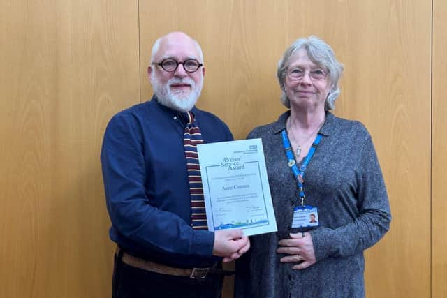 Anne Cossins with her Long Service Awards certificate at the celebration event. Left: Kevin Lockyer.