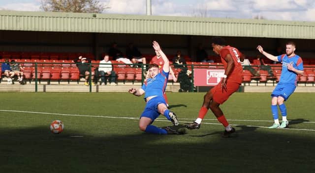 Akeel Francis slides home the second Sleaford goal. Photo: Steve W Davies Photography.