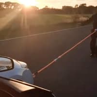 Strongman pulls car with tip of penis while dressed as Halloween's Michael Myers