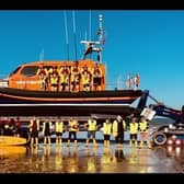 RNLI lifeguards (right) join RNLI volunteer lifeboat crews for a training operation.