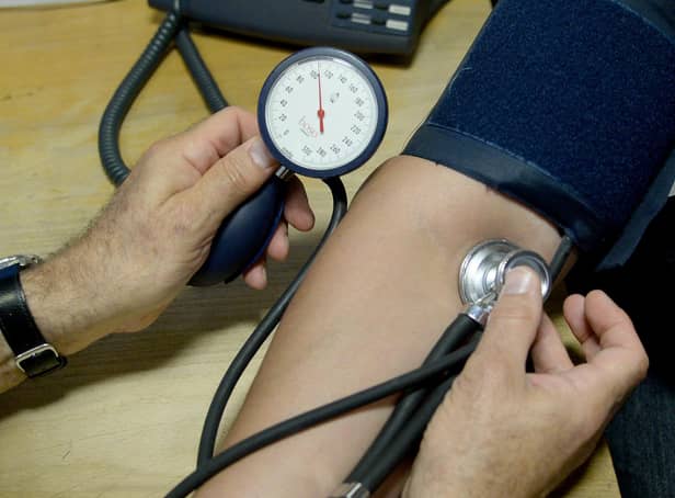Dr Laurence Buckman checks a patient's blood pressure in his practice room at Temple Fortune Health Centre GP Practice near Golders Green, London.