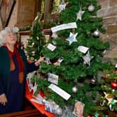 Visitors Gillian Sach (left) and Alison Fairchild, of Hemingby, admire one of the exhibits at the annual Christmas tree festival inside St Mary's Church, Horncastle.