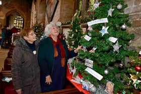 Visitors Gillian Sach (left) and Alison Fairchild, of Hemingby, admire one of the exhibits at the annual Christmas tree festival inside St Mary's Church, Horncastle.