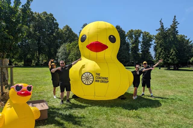 Coaching Inn Group team members Richard Clarke, Sam Bamford, Molly Knight and Donovan Vickery with the giant inflatable duck ... plus another inflatable duck, still pretty big, but much smaller.