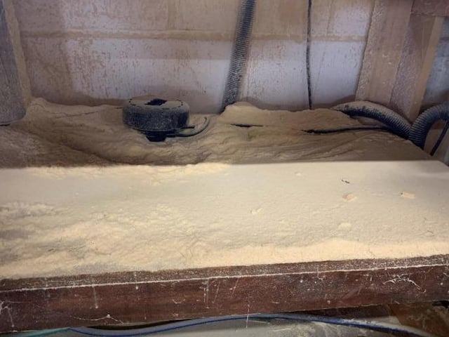 Drifts of wood dust below the chop saw bench at The Furniture Chest workshop. Photo: HSE