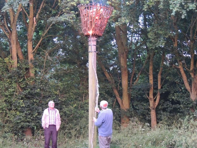 Lighting the beacon in the meadow behind Scopwick Village Hall.