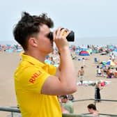 RNLI lifeguard Ethan Scott keeping watch over Skegness  beach