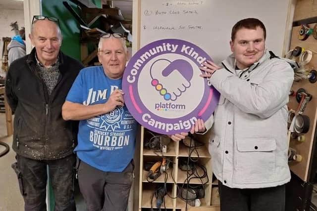 Three members of the Louth Men's Shed group holding aloft the logo for the 'Community Kindness' campaign, run by the Platform Housing Group. They are (from left): John Barlow, Harry Wyatt and Chris Exley. (PHOTO BY: Platform Housing Group)