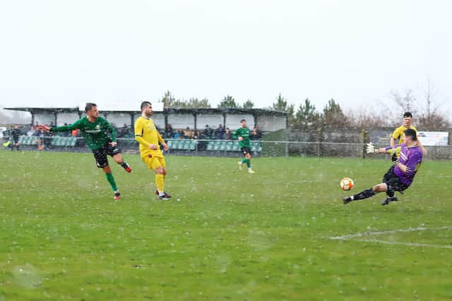 Joe Smith fires home Sleaford's second goal in the rain on Saturday. Photo: Steve W Davies Photography.