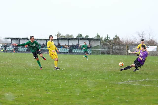Joe Smith fires home Sleaford's second goal in the rain on Saturday. Photo: Steve W Davies Photography.