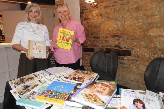 L-R - Linda Harris and Dee Murray with the cook book swap where people could swap or buy books, with proceeds going to the Alzheimer's Society.