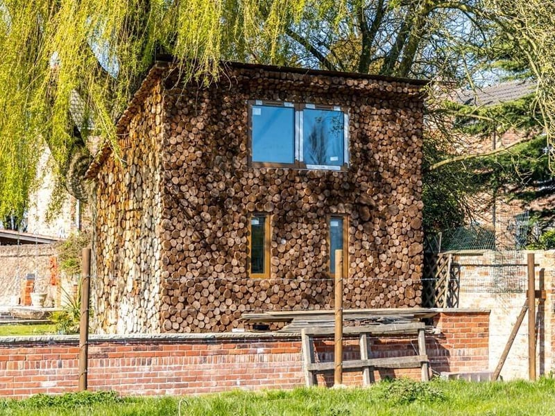 The two-storey 'log house', which has been used as a child's playhouse.