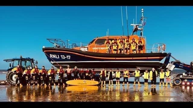 RNLI lifeguards (right) join RNLI volunteer lifeboat crews in Skegness for a training operation.