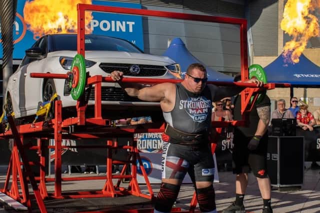 Giving a lift to a car ... Dean Mason, of Boston, in the UK's Strongest Man 2025 contest.