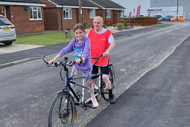 Roger Fixter, of Boston, who has complete vision loss and is appealing for help in training for The Butterfly Hospices' Big Bike Ride 2022; pictured, here, with granddaughter Ruby.