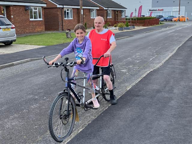 Roger Fixter, of Boston, who has complete vision loss and is appealing for help in training for The Butterfly Hospices' Big Bike Ride 2022; pictured, here, with granddaughter Ruby.