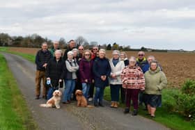 Some of the residents opposed to the plans pictured on Church Lane in Sutterton - with the proposed sites either side of the narrow lane.