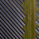 An aerial view of photovoltaic panels at a solar farm.