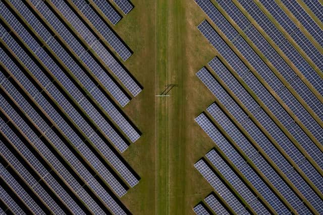 An aerial view of photovoltaic panels at a solar farm.