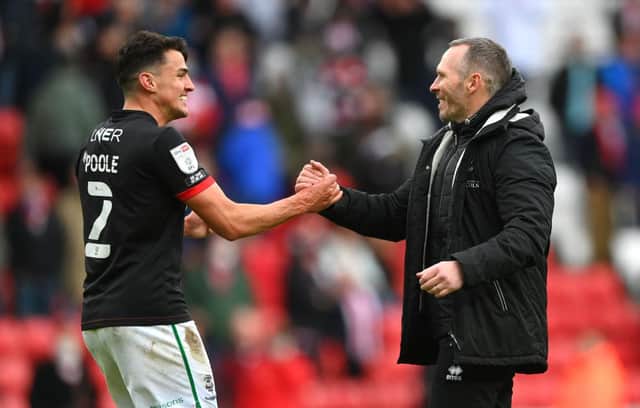Lincoln City manager Michael Appleton congratulates Regan Poole after reaching the final of the League One play-offs.