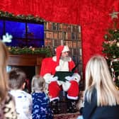 Santa reading a Christmas story to children in his lodge. Photo: Chris Vaughan