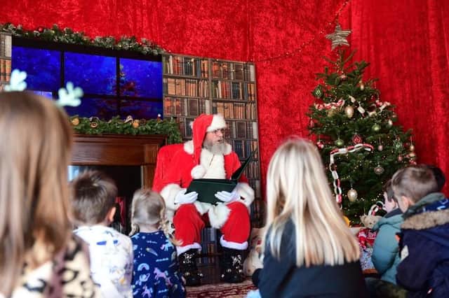 Santa reading a Christmas story to children in his lodge. Photo: Chris Vaughan